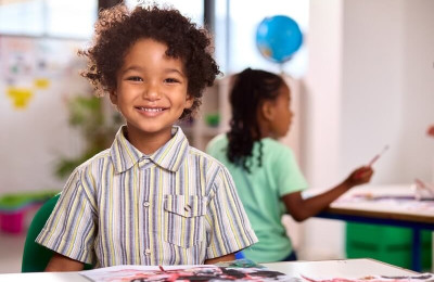 Smiling kid in class