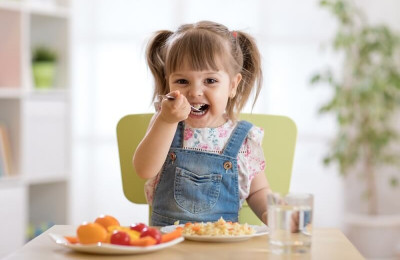 little girl eating healthy food