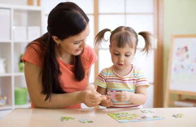 mom giving her child a puzzle piece