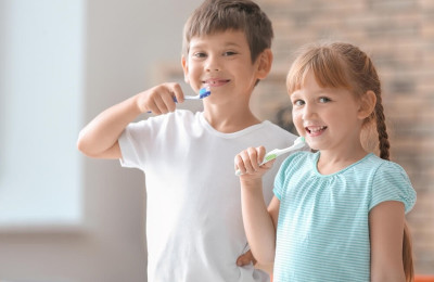 Cute little children brushing teeth at home